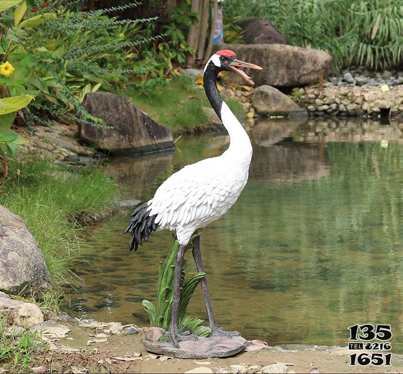 仙鶴雕塑-景區(qū)池塘一只捕魚覓食的玻璃鋼仙鶴雕塑高清圖片